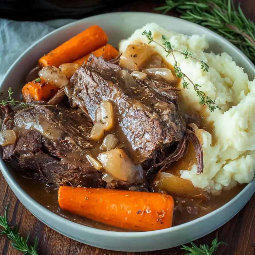 A bowl filled with grilled beef, potatoes, carrots, and other veggies.