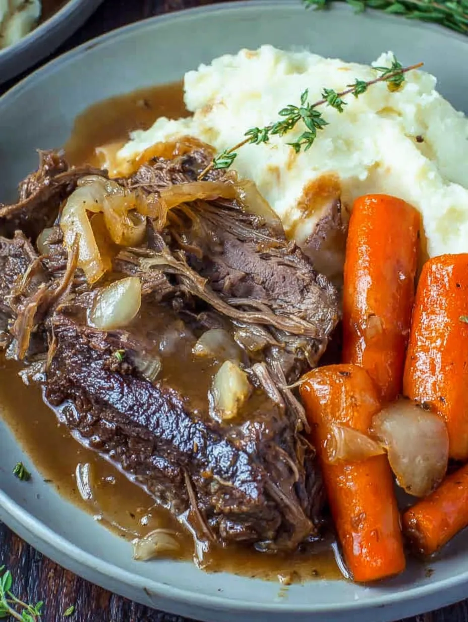A plate with grilled beef, potatoes, onions, and gravy.