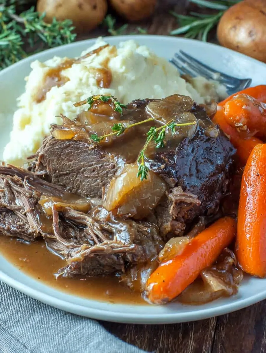 A plate with grilled beef, potatoes, gravy, and onions.