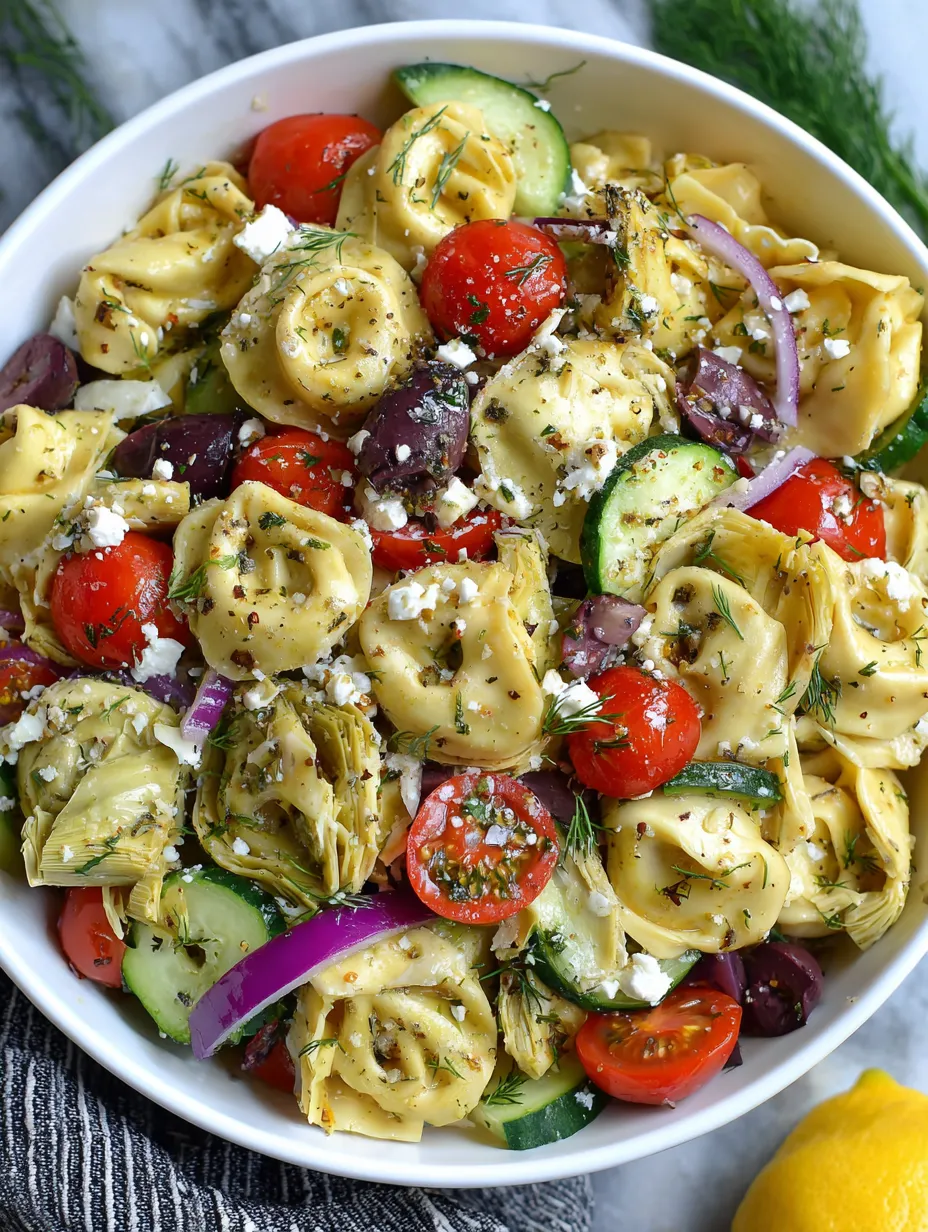 A white cup filled with pasta, tomatoes, zucchini, basil, and Parmesan.